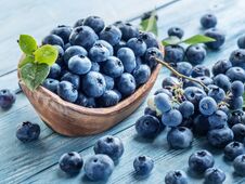 Blueberries In The Wooden Bowl On The Table. Royalty Free Stock Photography