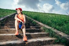 An Asian Woman Athletic Is Jogging On The Concrete Road, Royalty Free Stock Images
