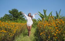 Happy And Beautiful Young Asian Woman Relaxing Enjoying The Fresh Beauty Of Gorgeous Orange Marigold Flowers Field Natural Royalty Free Stock Photos