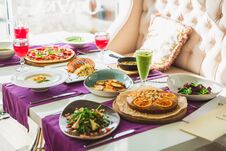 Table In Restaurant With Vegetarian Dishes - Pizza, Salads, Pie And Fresh Natural Drinks. Royalty Free Stock Photo