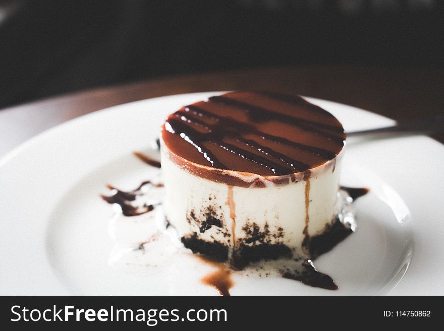 Black, Brown, and White Melted Cake on Round White Ceramic Plate