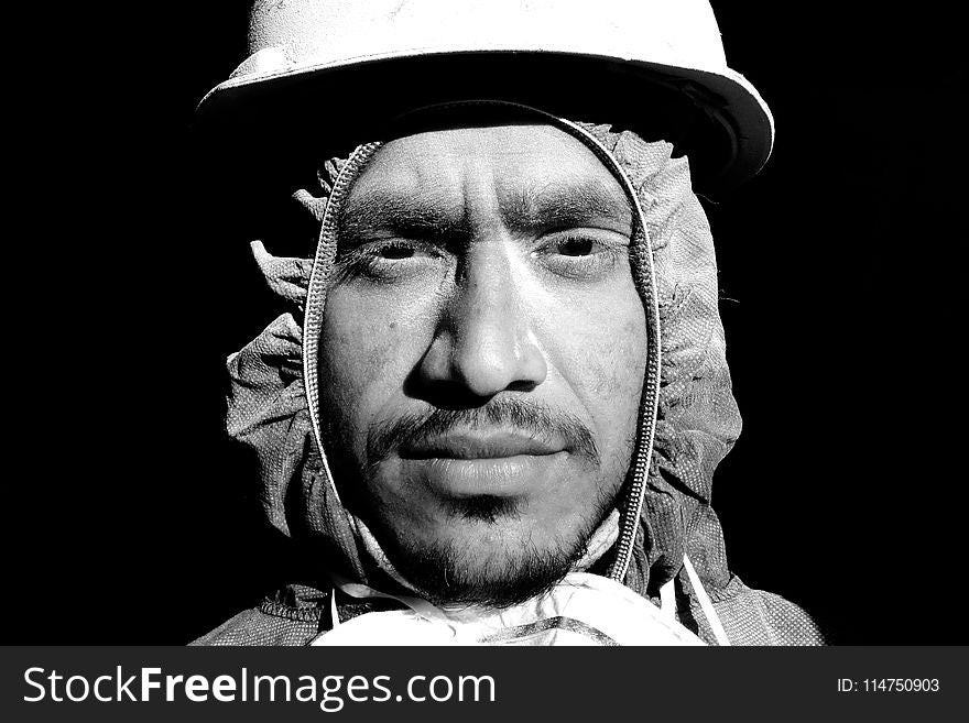 Grayscale Photograph of Man Wearing Hooded Top and Hard Hat