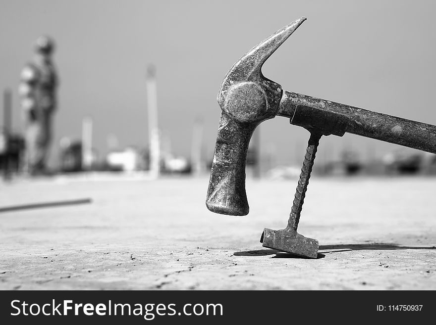 Grayscale Photo Of Hammer On Pavement