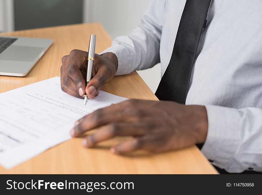 Person Wearing White Dress Shirt Signing Contract