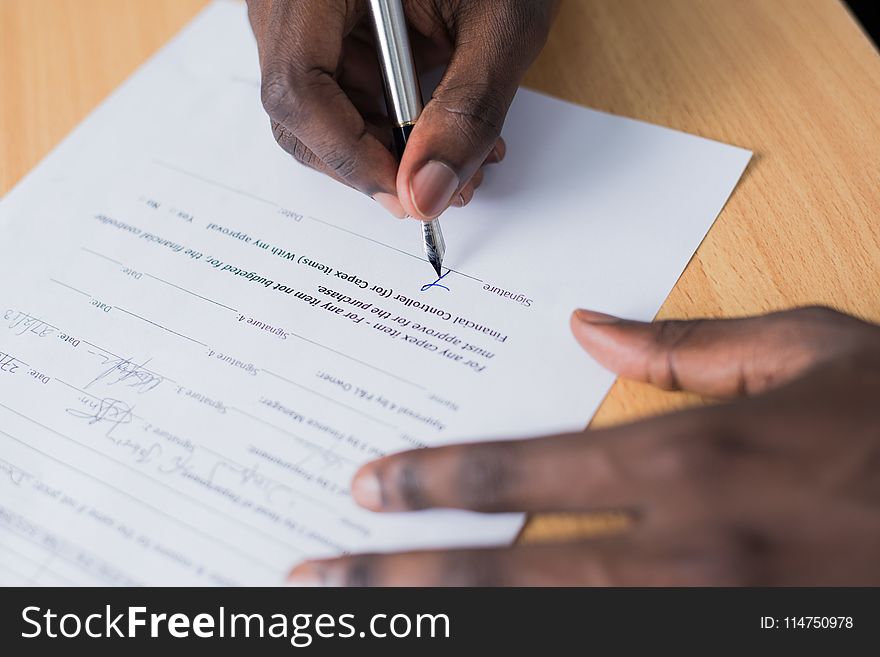 Person Signing Paper