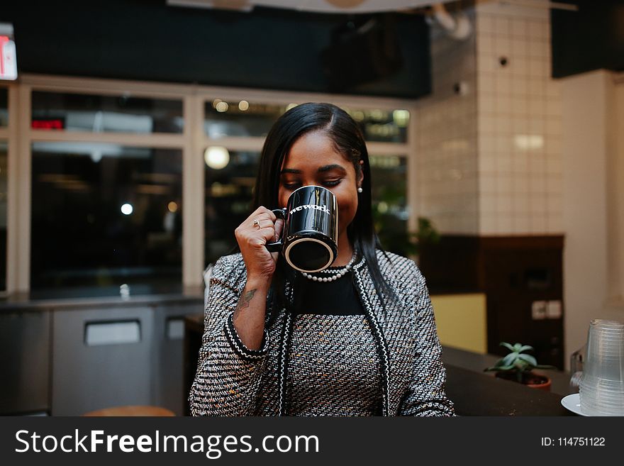 Photo of Woman Holding Black Mug