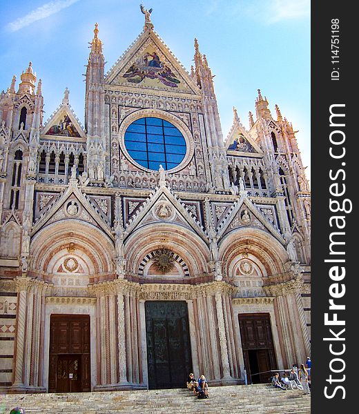 People Sitting On Stairs Of Cathedral