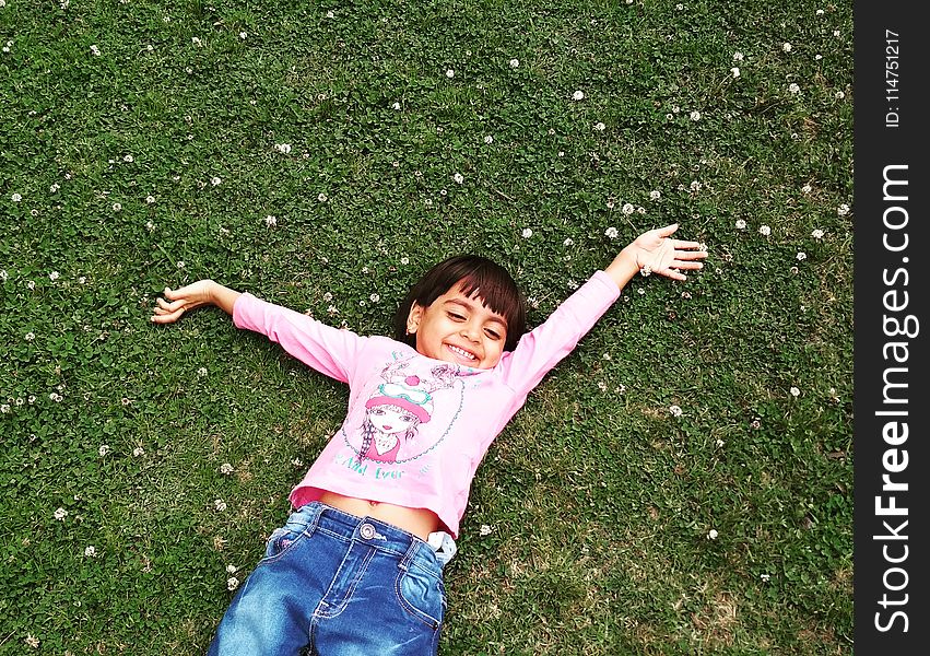 Girl Laying On Green Grass