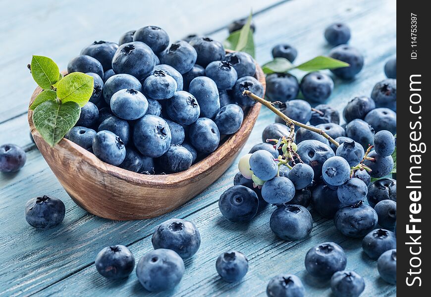 Blueberries In The Wooden Bowl On The Table.