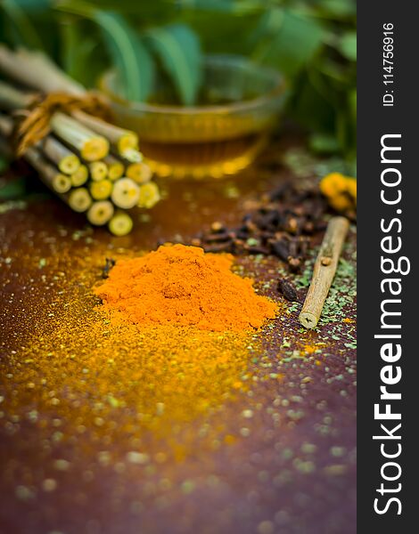 Powder of Indian lilac,Azadirachta indica in a glass plate with its leaves and raw underpowered turmeric.