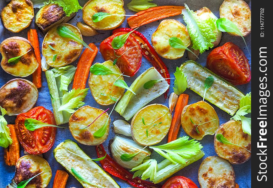 Baked vegetables in large pieces on parchment. Tasty and healthy village food. Baked vegetables in large pieces on parchment. Tasty and healthy village food.