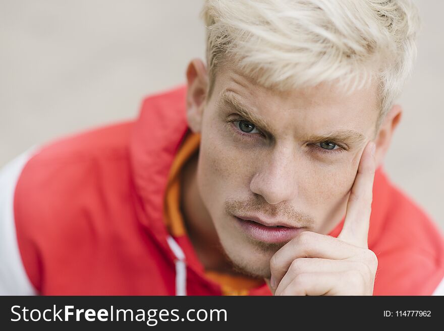 Close up portrait of handsome blond smiling man wlaking in the park. Happy male with healthy smile in outdoor. Lifestyle, people, travel concept.