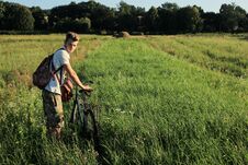 Boy Holding And Riding A Bicycle In A Field On A Sunny Summer Da Royalty Free Stock Photos