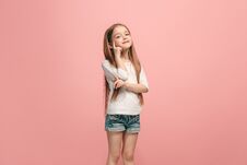 The Happy Teen Girl Standing And Smiling Against Pink Background. Royalty Free Stock Photo