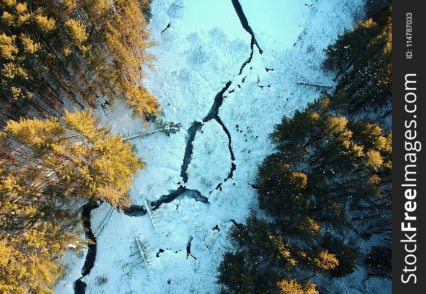 Aerial drone shot of Winding river through the winter forest. Upstate New York, 2018. Aerial drone shot of Winding river through the winter forest. Upstate New York, 2018