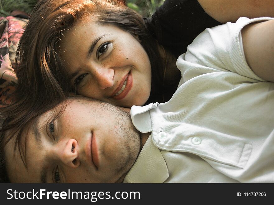 Happy couple faces having fun on a summer picnic, tender feelings, selfie