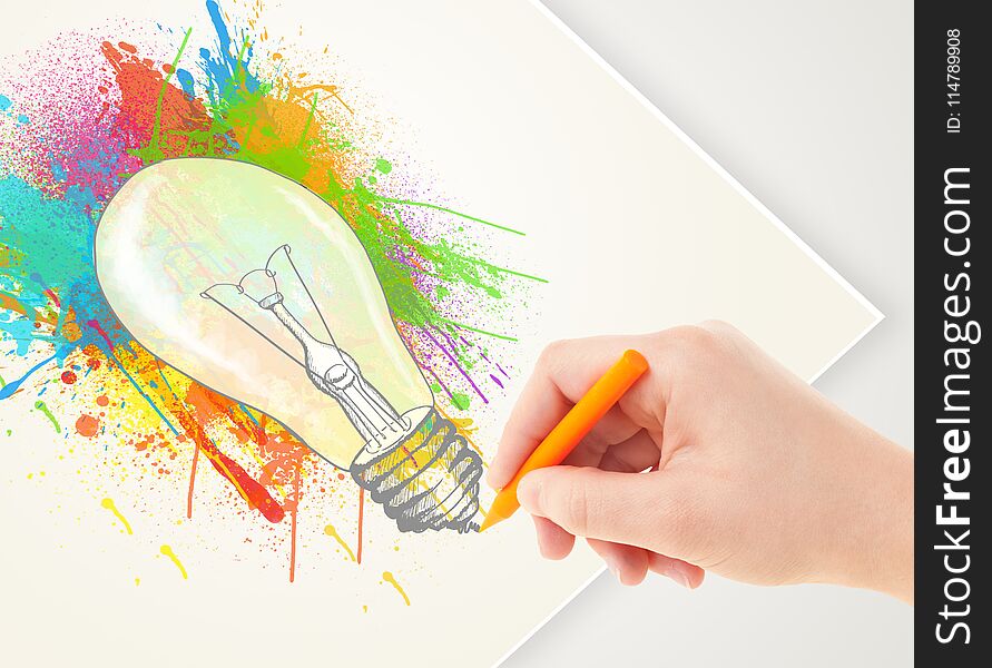 Hand drawing on a plain paper a colorful splatter lightbulb