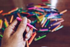 Stack Of Colored Pencils In Hands Stock Image
