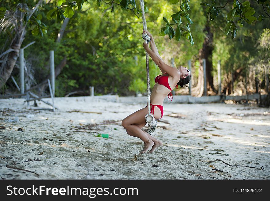 Woman Wearing Red Bikini Swinging