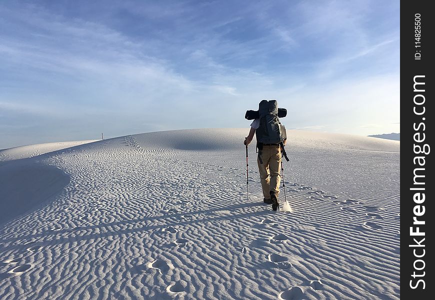 Photo Of Man Holding Hiking Poles On Snow Field