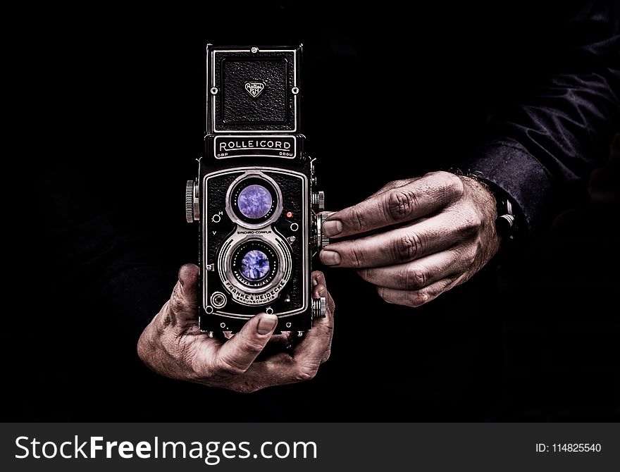 Person Holding Black Twin-lens Reflex Camera