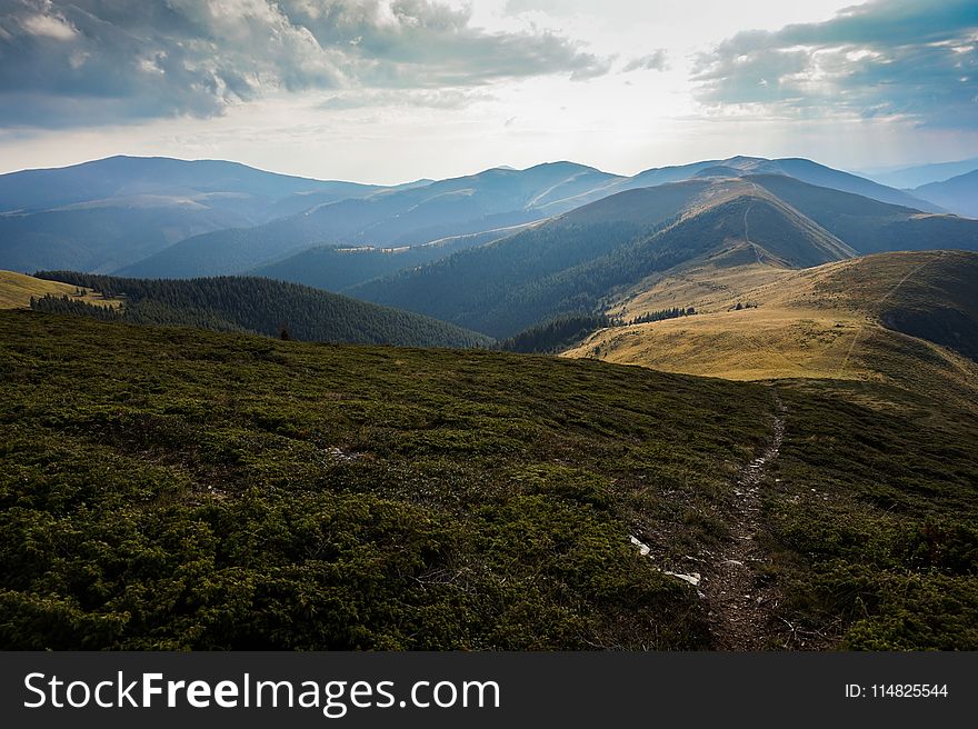 Aerial Photography of Mountain Under Cloudy Sky