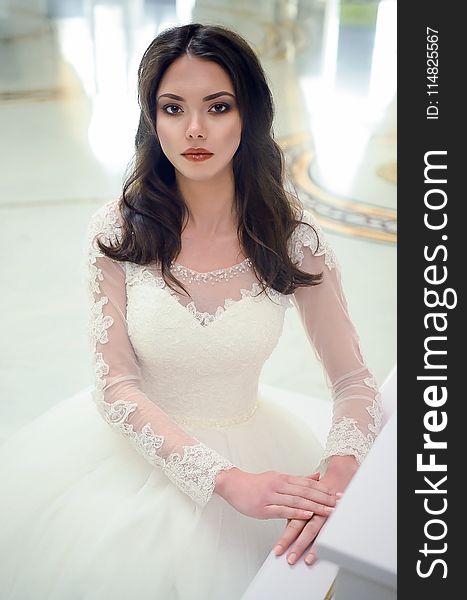 Women in White Long-sleeved Bridal Gown
