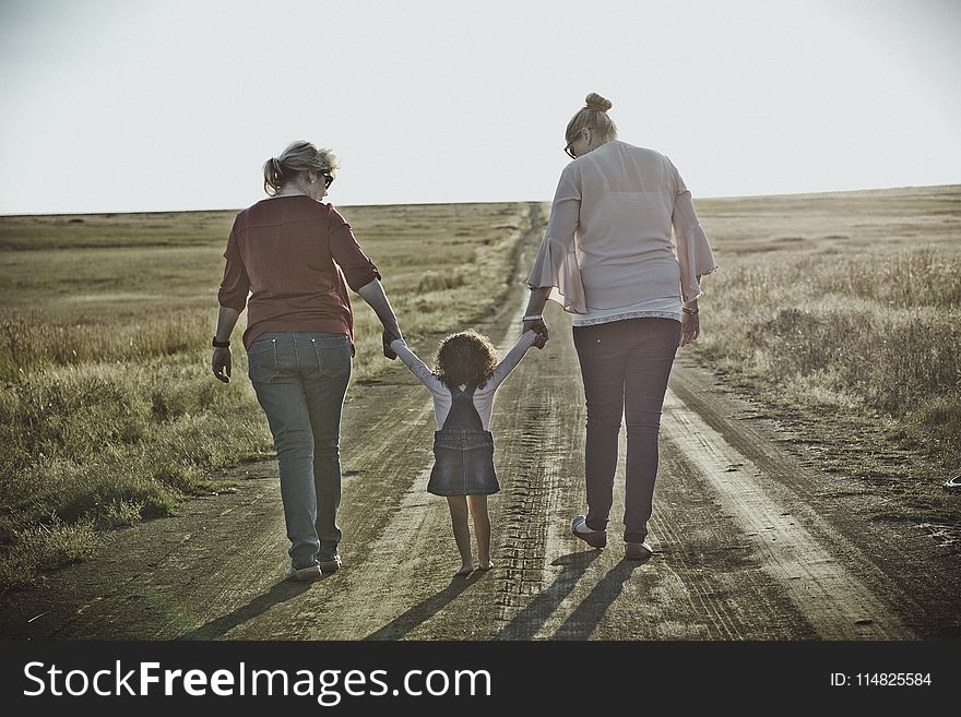 Photography of Women Walking on Dirt Road