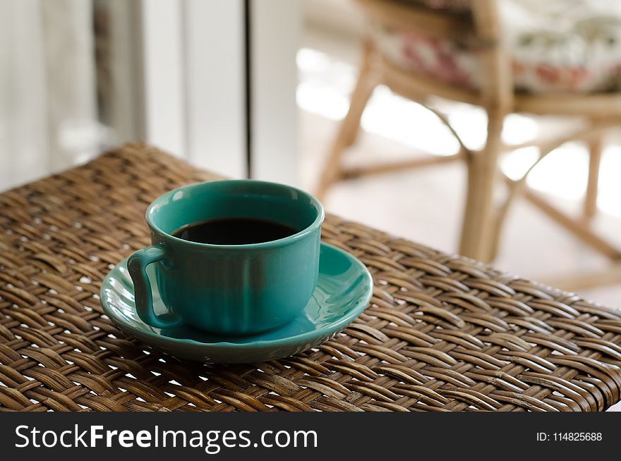 Blue Coffee Cup With Saucer Filled With Coffee on Top of Wicker Table