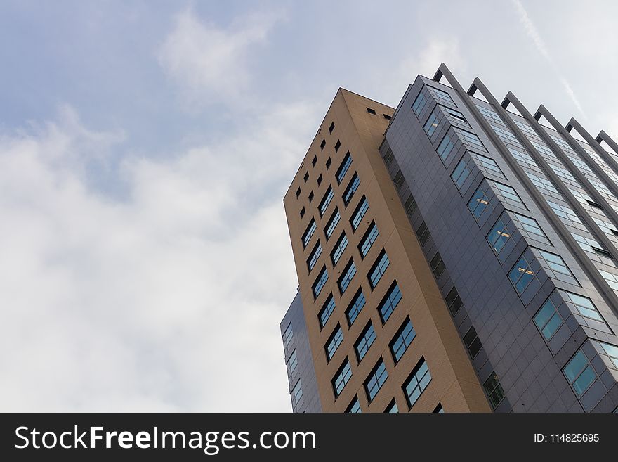 Worm&#x27;s-eye View of High Rise Building Under White Sky