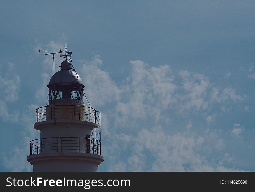 White Lighthouse Under Blue Sky And White Clouds