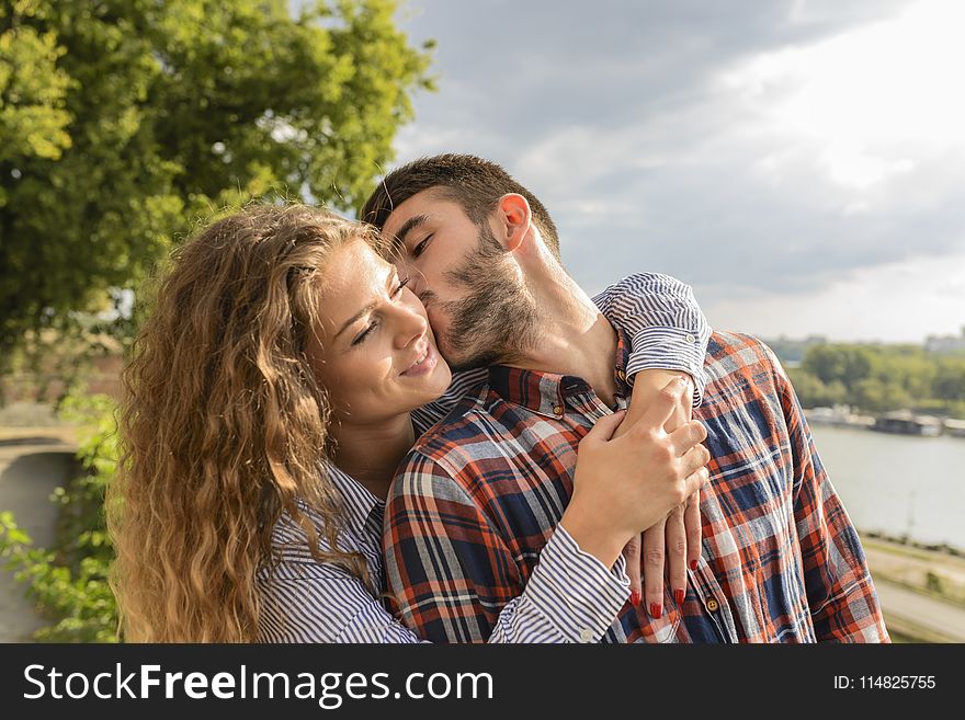Man Kissing Woman