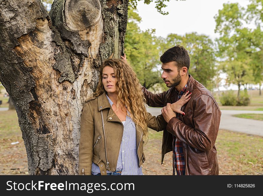 Man And Woman Wearing Brown Full-zip Jackets