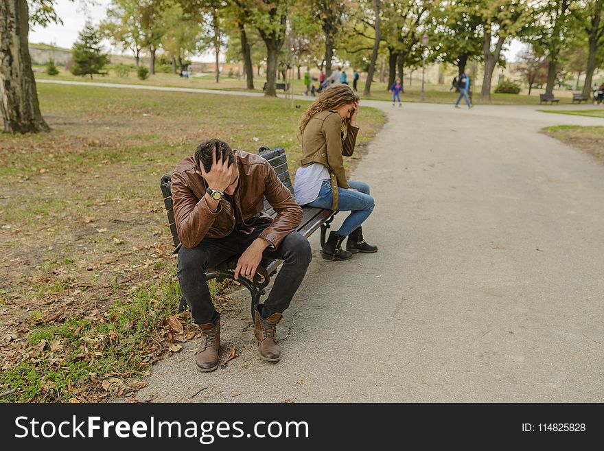 Man And Woman Sitting On Bench