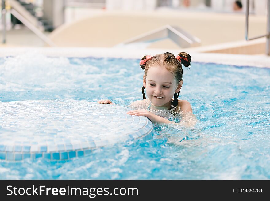 Young girl swimming in a hot tub.