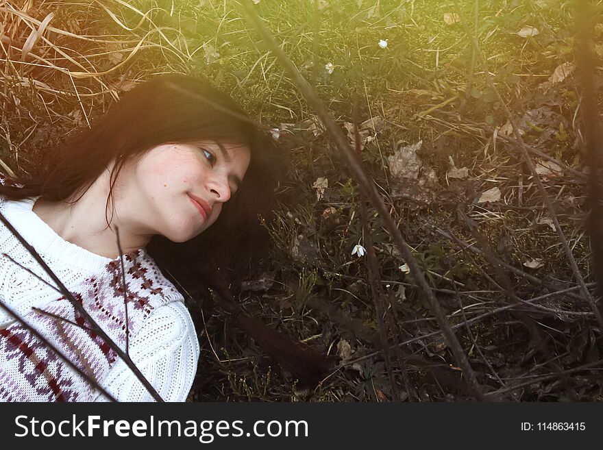 Stylish Brunette Girl Traveler Lying With Snowdrops On The Background Of Mountains In Spring Time