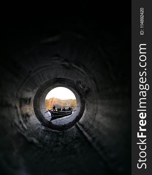 People Riding Canoe Boat View from Inside Pipe