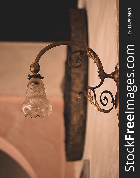 Selective Focus Photography of Brown Framed Sconce