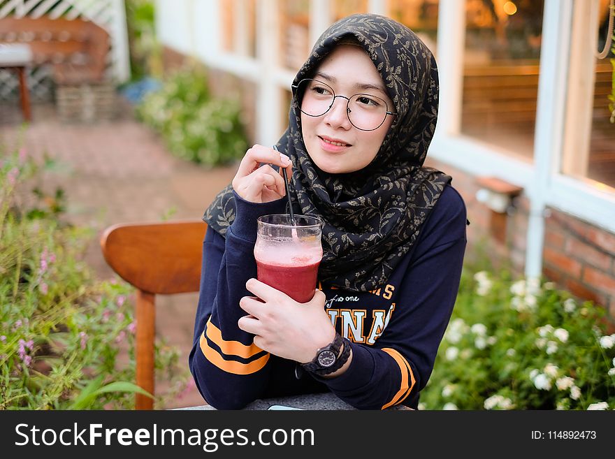 Woman Holding Cup of Red Juice