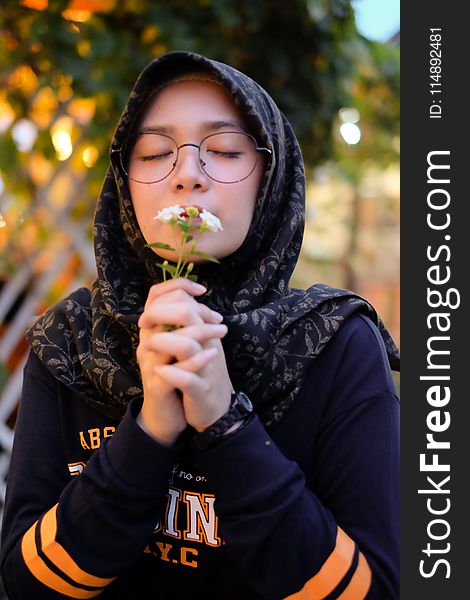 Photo Of Girl Smelling White Petaled Flowers