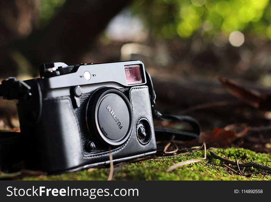Selective Focus Photo of Black Fujifilm Camera on Ground