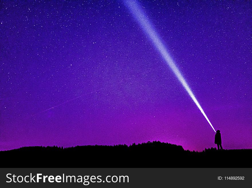 Silhouette of Person Under Blue and Purple Sky