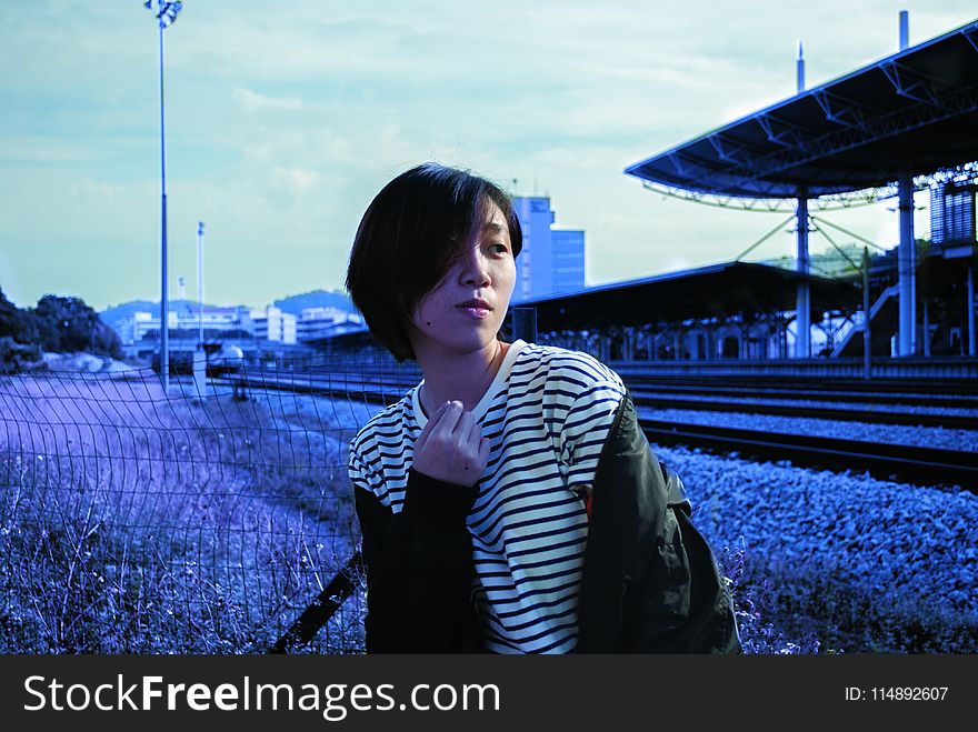 Lady In White Pinstripe Scoop-neck Shirt And Black Jacket