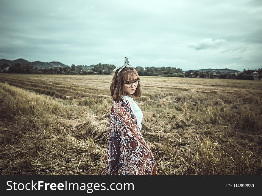 Woman in Brown and Black Floral Scarf