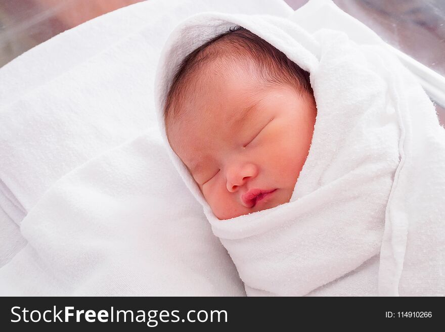 Cute newborn asian baby girl sleeping