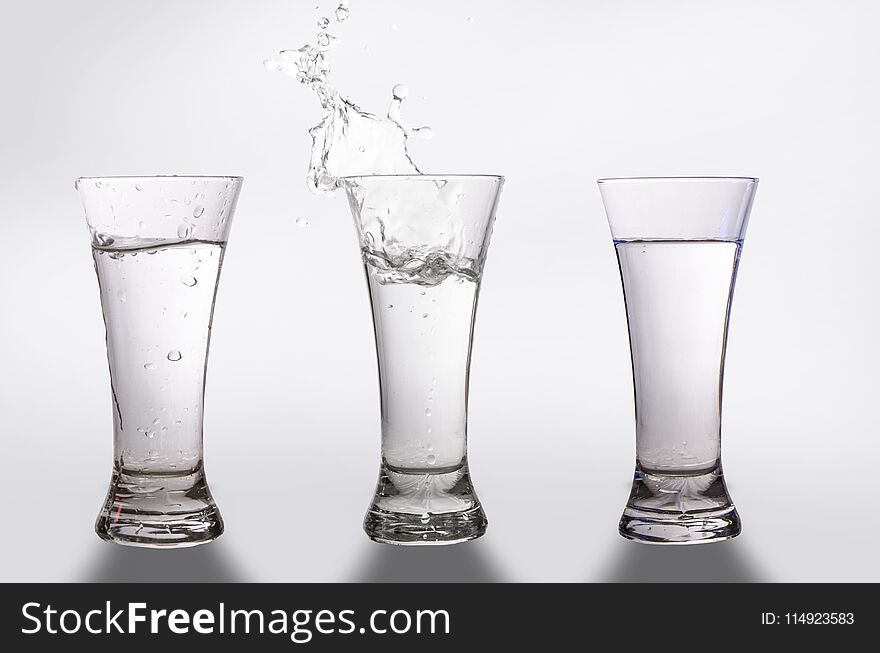 Three glasses and a splash of water