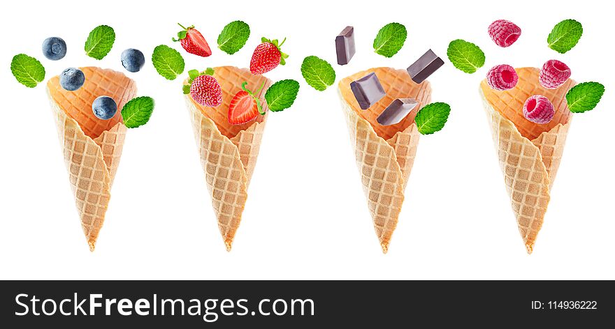 Variation of waffle cones with flying berries and chocolate slices isolated