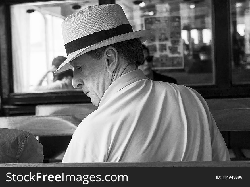 Man Wearing Polo Shirt and Hat in Grayscale Photo