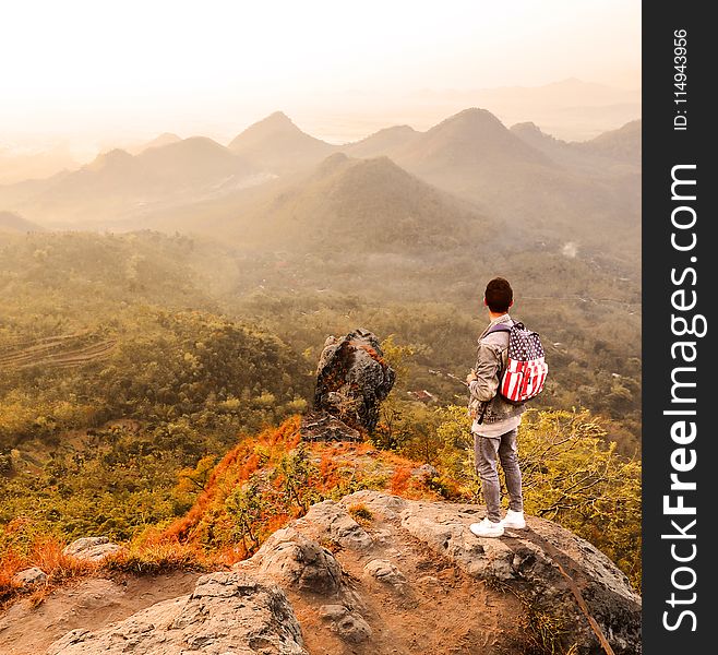 Man Standing on a Mountain Summit