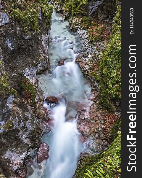 Body Of Water Between Cliffs Covered With Moss